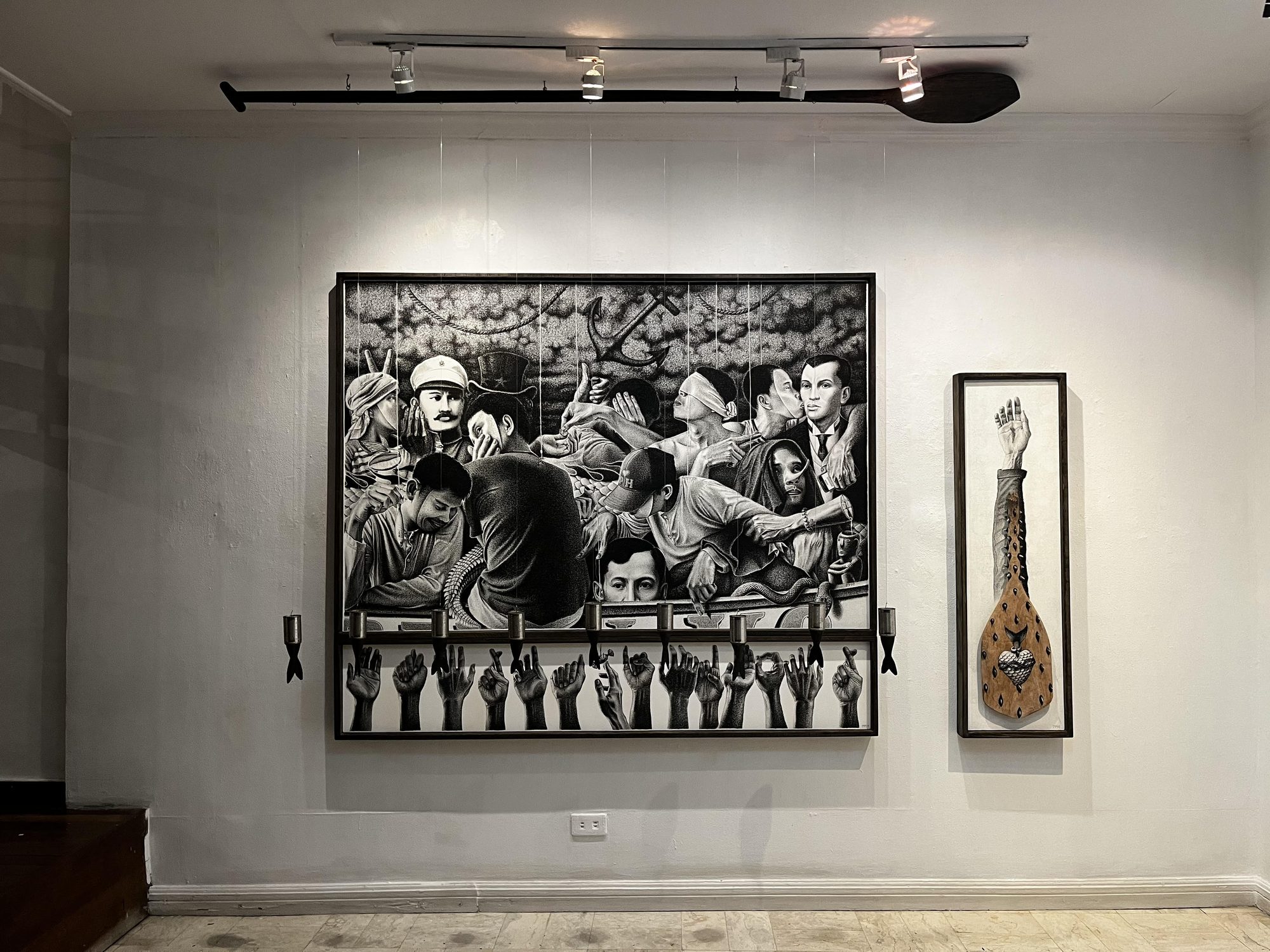 Langit Lupa installation view: Kargado hung above Kapalaran with tin-can fish suspended on lines, a paddle mounted overhead